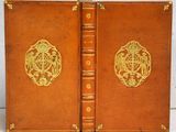 an old book with a golden design on the front and back