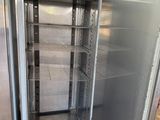 an open refrigerator that is sitting in the middle of a room