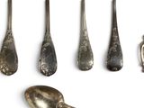 several spoons and spoon spoons are lined up on a white surface
