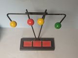 an image of a wooden toy with colorful balls on it