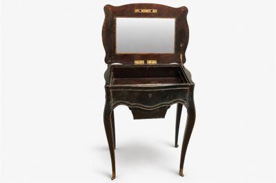 an old wooden vanity with a mirror on top of it