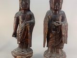 pair of asian carved wood figures of buddhas on pedestals
