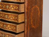 an image of a wooden chest of drawers with a clock on top of it