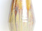 a vase that is sitting on a white surface
