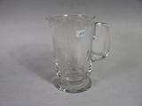 a glass mug that is sitting on a table