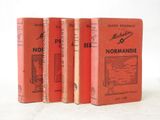 three red books sitting on top of each other on a white surface