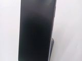 an image of a cell phone on a stand on a white surface