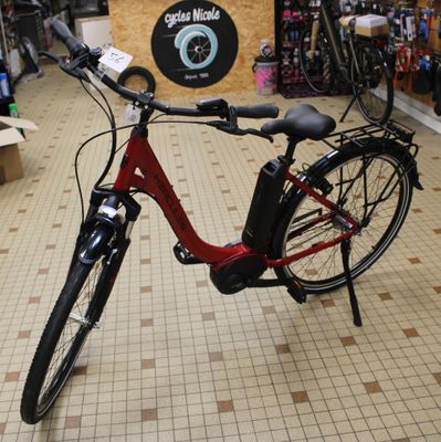 a red bike that is parked in a store