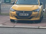 a yellow car that is parked on the side of the road
