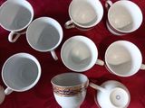 a lot of cups and saucers on a table