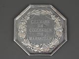 an old silver coin with a wreath of flowers on it