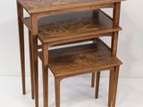 three wooden nesting tables with a shelf on top of them
