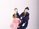 a figurine of a man and a woman sitting on a bench