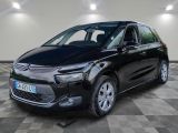 une Citroën noire garée dans un garage au sol carrelé