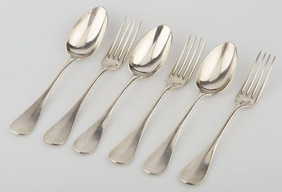 six silver spoons and a fork on a white surface