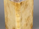 an old book with a bookmark sticking out of it ' s cover