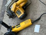 two electric tools on the ground next to each other