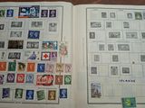 an open book with stamps on it sitting on top of a table
