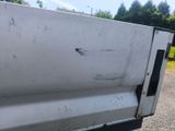 a close up of a white truck with rust on the side