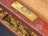 a close up of a wooden table with a brass plate on it