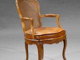 a wooden chair with a cane back and a cane seat