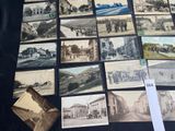 a lot of old photos on display on the table