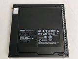 the back side of a laptop with a battery on top of it