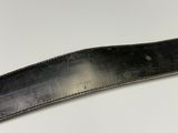 a close up of a knife on a white surface