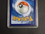 a pokemon card in a plastic case on a table