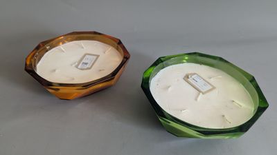 candles are sitting on a table next to each other on a table