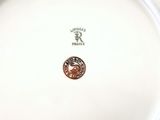 a white plate with a brown and black design on it
