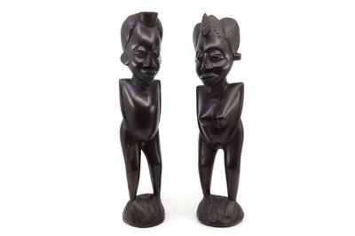 pair of african carved wooden figures of a man and a woman