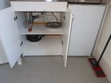 a small kitchen with a stove, sink, and a dishwasher