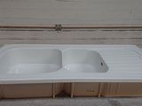 a white sink sitting on top of a cardboard box