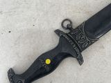 a knife that is laying on the ground on the floor
