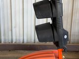 an orange machine that is sitting on the ground