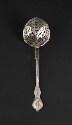 a close up of a spoon on a black surface with a black background