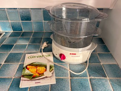 a food processor sitting on the counter next to a packet of food