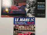 three books on the wall of a room with pictures of racing cars