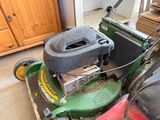 a lawn mower that is sitting in the garage