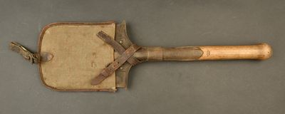 a wooden paddle with a leather handle on a table