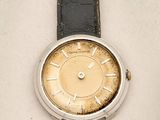 a watch that is sitting on a white surface