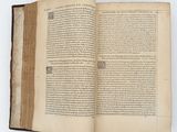 an open book with a page in it sitting on top of a table