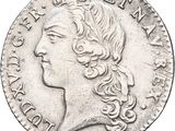 gros plan d'une pièce de monnaie sur laquelle figure un visage de femme
