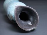 a close up of a blue vase on a table
