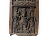 an image of a wooden wall hanging with a statue of a man and a woman