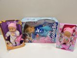 three dolls that are sitting next to each other on a table