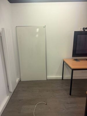 a small room with a desk and a television