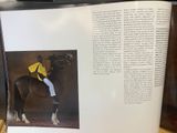 an open book with a picture of a man riding a horse