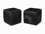 pair of black velvet cube stools on a white background